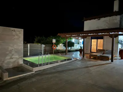 a tennis court on a patio at night at Aleyna house Lindos area in Líndos