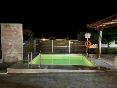 a swimming pool at night with two faucets at Aleyna house Lindos area in Líndos