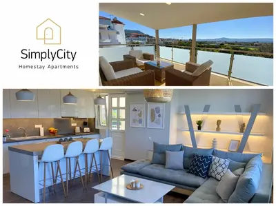 a kitchen and a living room with a couch at SimplyCity Homestay Apartment 1 in Kremasti