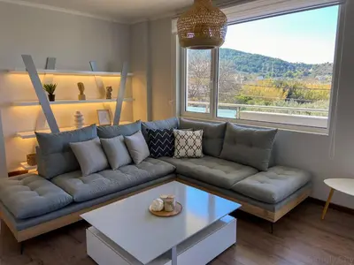 a living room with a couch and a table at SimplyCity Homestay Apartment 1 in Kremasti