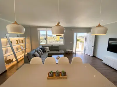 a living room with a couch and a table at SimplyCity Homestay Apartment 1 in Kremasti