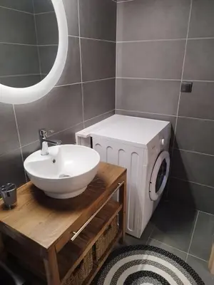 a bathroom with a sink and a washing machine at Melograno di Rodi 4 in Rhodes Town