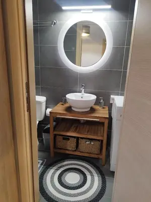 a bathroom with a sink and a mirror at Melograno di Rodi 4 in Rhodes Town