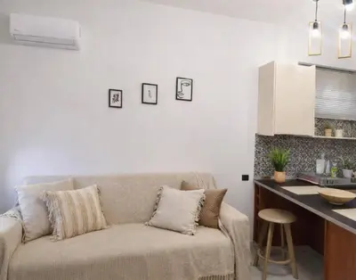 a living room with a couch and a counter at Melograno di Rodi 4 in Rhodes Town