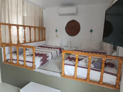 a room with two beds and a flat screen tv at Cavo Prima Kiotari in Gennadi