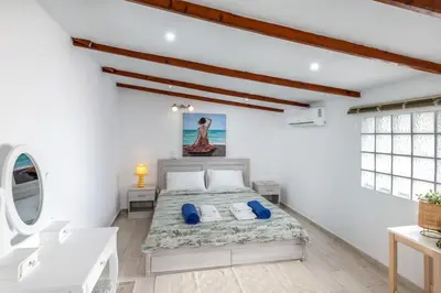 a bedroom with a bed in a white room at Cavo Prima Kiotari in Gennadi