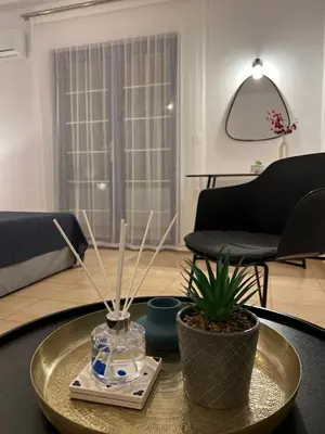 a living room with a table with a plant on it at Elefanti Nani in Livadia