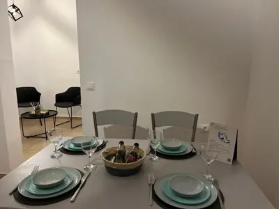 a table with plates and glasses and a basket on it at Elefanti Nani in Livadia