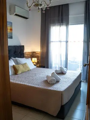 a bedroom with a bed with two towels on it at Villa Nektarina in Afantou
