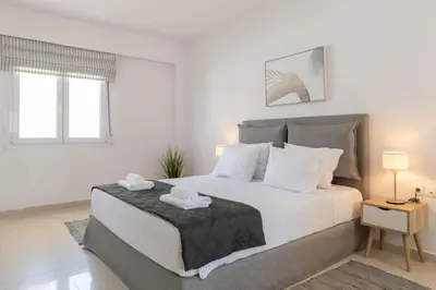 a bedroom with a large bed with two towels on it at Island Hills in Rhodes Town
