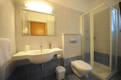 a bathroom with a sink and a toilet and a shower at Golden View Studios in Líndos