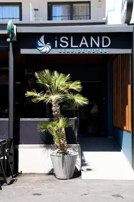 a plant in a pot in front of a restaurant at Island Sea Side Hotel - Adults Only in Rhodes Town