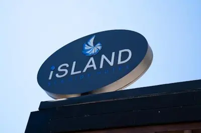 a blue and white sign on top of a building at Island Sea Side Hotel - Adults Only in Rhodes Town