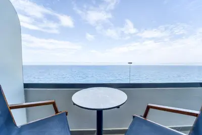 a table and chairs on a balcony with a view of the ocean at Island Sea Side Hotel - Adults Only in Rhodes Town