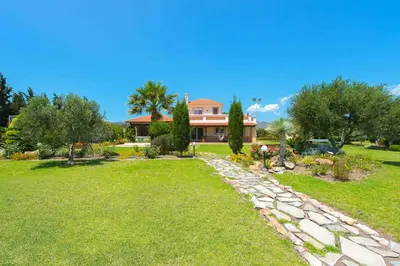 a house with a garden and a pathway at Villa Amelia in Gennadi