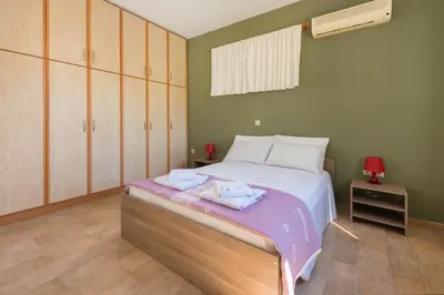a bedroom with a bed with two towels on it at Villa Amelia in Gennadi