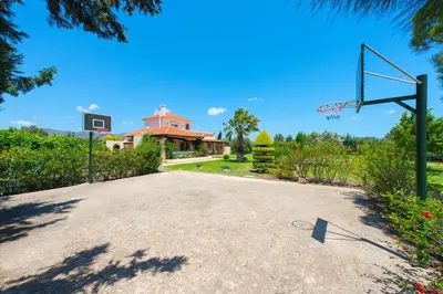 an empty basketball hoop in front of a house at Villa Amelia in Gennadi