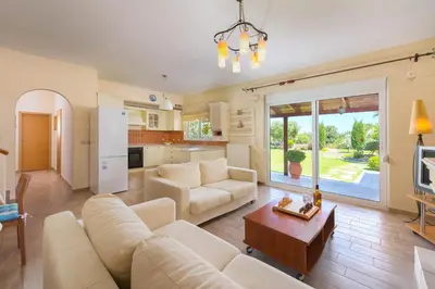 a living room with a couch and a table at Villa Amelia in Gennadi
