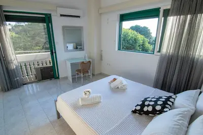 a room with a bed with two towels on it at Christos Apt - City Center w/ Royal Garden View in Rhodes Town