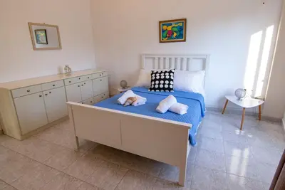 a bedroom with a bed with two pillows on it at Christos Apt - City Center w/ Royal Garden View in Rhodes Town