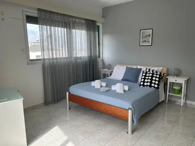 a bedroom with a bed with towels on it at Christos Apt - City Center w/ Royal Garden View in Rhodes Town