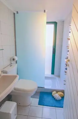 a bathroom with a toilet and a tub and a sink at Christos Apt - City Center w/ Royal Garden View in Rhodes Town