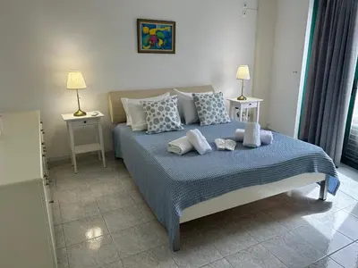 a bedroom with a bed with pillows on it at Christos Apt - City Center w/ Royal Garden View in Rhodes Town