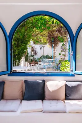 an arched window with a couch in a room at Hotel Nathalie in Ixia