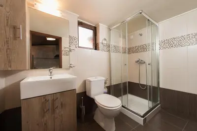 a bathroom with a toilet and a sink and a shower at Xenios Zeus Maisonettes Old Town Rhodes in Rhodes Town