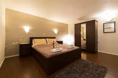 a bedroom with a bed with two towels on it at Xenios Zeus Maisonettes Old Town Rhodes in Rhodes Town