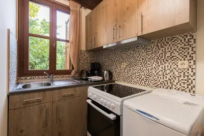 a kitchen with a sink and a stove top oven at Xenios Zeus Maisonettes Old Town Rhodes in Rhodes Town