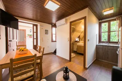 a kitchen and dining room with a table and chairs at Xenios Zeus Maisonettes Old Town Rhodes in Rhodes Town
