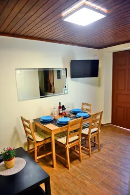 a dining room with a wooden table and chairs at Xenios Zeus Maisonettes Old Town Rhodes in Rhodes Town