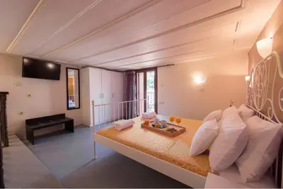 a living room with a couch and a table at Xenios Zeus Maisonettes Old Town Rhodes in Rhodes Town