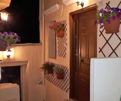 a room with a door and potted plants on the wall at Xenios Zeus Maisonettes Old Town Rhodes in Rhodes Town