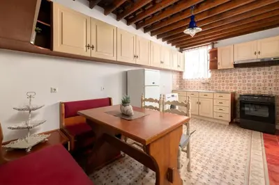 a kitchen with a wooden table in a room at Lindos Villa Petra with Acropolis View in Líndos