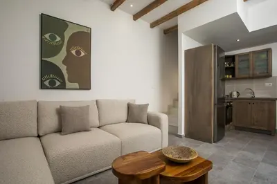 a living room with a couch and a table at Pera houses 2-bedroom in the center of Lindos in Líndos