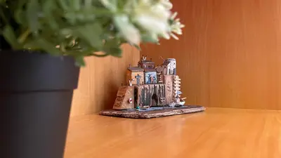 a toy house sitting on a table next to a plant at Niochori Heritage: The Mermaid Suite in Rhodes Town