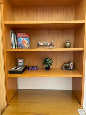 a book shelf with a toy train and books at Niochori Heritage: The Mermaid Suite in Rhodes Town