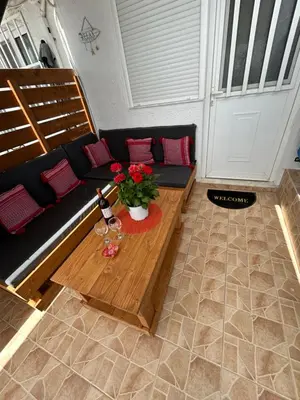 a living room with a couch and a table with flowers at Maroulitsas Sea Esta 1 in Haraki