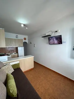 a living room with a couch and a kitchen at Maroulitsas Sea Esta 1 in Haraki