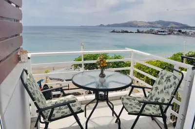 a table and two chairs on a balcony with the ocean at Maroulitsas Sea Esta 2 in Haraki
