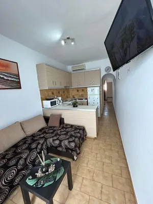 a living room with a couch and a kitchen at Maroulitsas Sea Esta 2 in Haraki