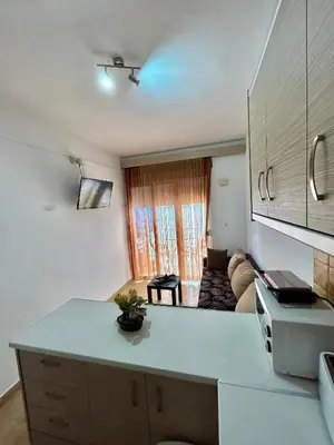 a kitchen with a counter top and a living room at Maroulitsas Sea Esta 2 in Haraki