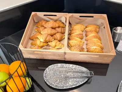 two wooden boxes filled with food on top of a table at Angela Downtown Hotel in Rhodes Town