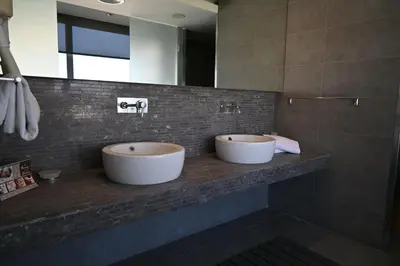 two sinks on a counter in a bathroom at Angela Downtown Hotel in Rhodes Town