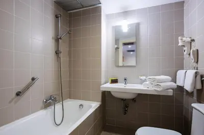 a bathroom with a sink and a tub and a toilet at Angela Downtown Hotel in Rhodes Town