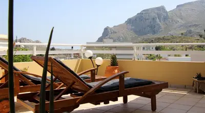a balcony with chairs and a view of a mountain at Beautiful penthouse studio for 2 in Archangelos