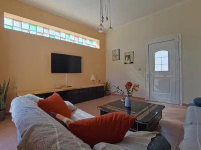 a living room with a couch and a tv at Beautiful apartment with 3 bedrooms in Archangelos