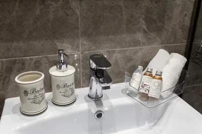 a bathroom sink with two cups and a coffee maker at Danae Luxury Apartment - Rhodes in Rhodes Town